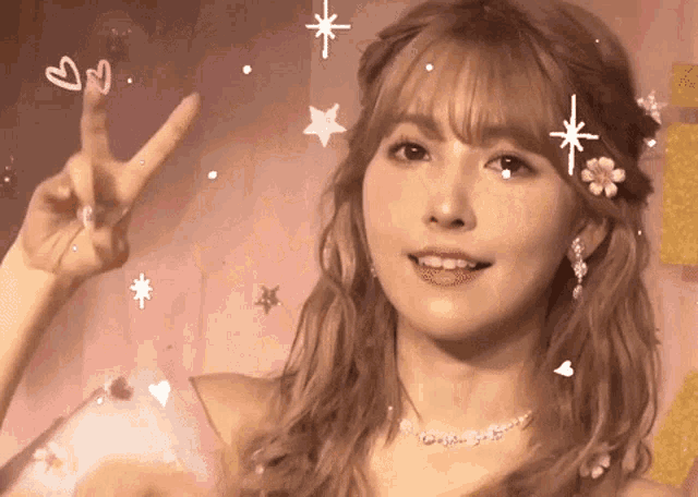 a woman giving a peace sign with hearts and stars around her