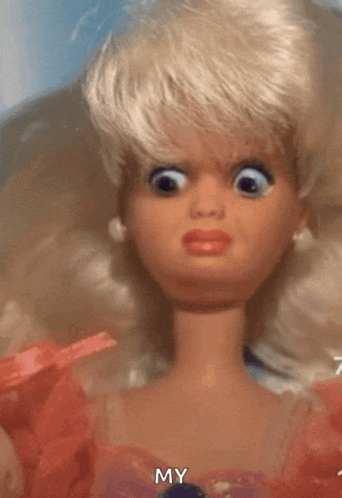 a close up of a barbie doll making a funny face with my written on the bottom