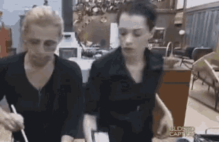 two women standing next to each other in a kitchen with the words closed caption on the bottom left