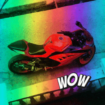 a red kawasaki motorcycle is sitting on a sidewalk next to a rainbow