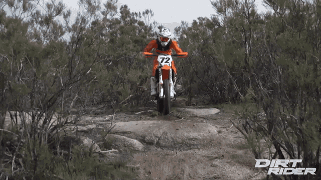 a dirt rider with the number 72 on the front of his motorcycle