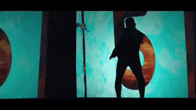 a silhouette of a man is dancing in front of a large number 5