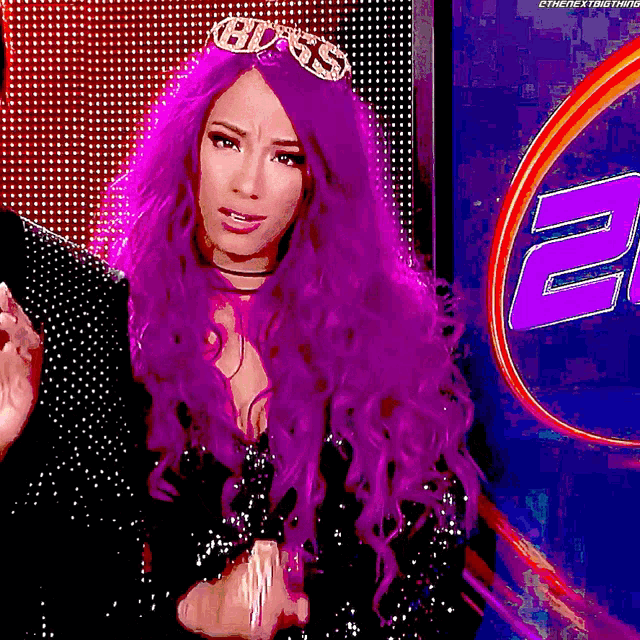 a woman with purple hair wears a tiara that says boss