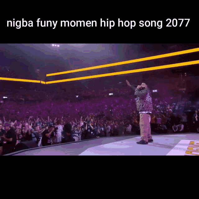 a man stands on a stage in front of a crowd with the words nigba funy momen hip hop song 2077 above him