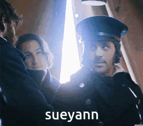 a man wearing a hat with the name sueyann written on it