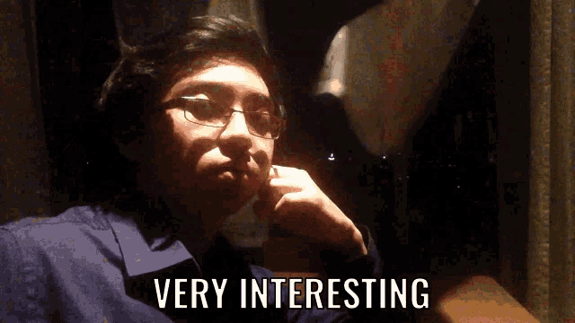 a man with glasses says very interesting in front of him