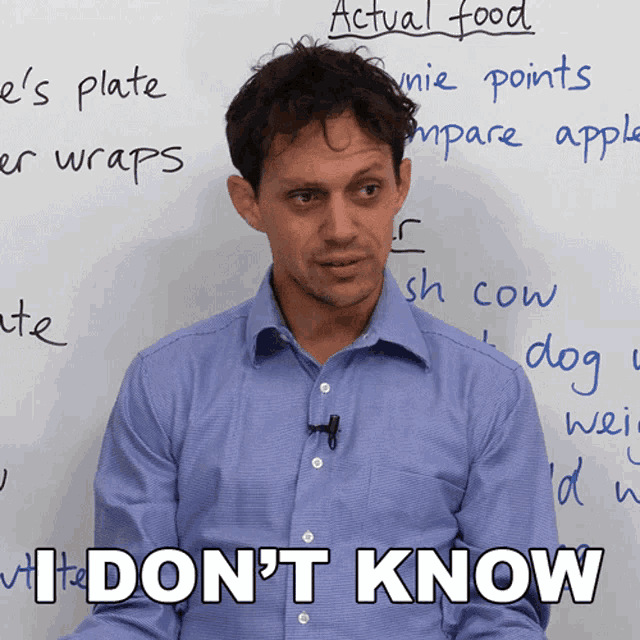 a man stands in front of a white board with the words actual food written on it