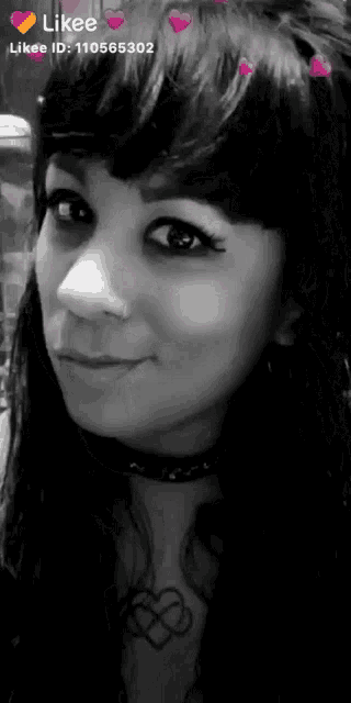 a black and white photo of a woman 's face with hearts on her hair .