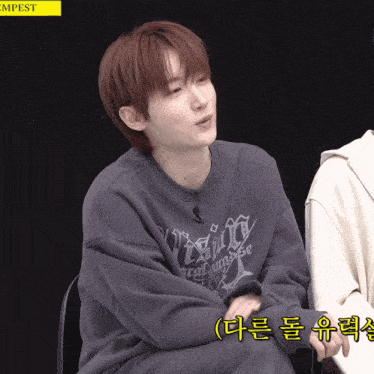 a young man wearing a sweatshirt that says tempest