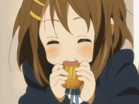 a girl in a school uniform is eating a donut with her eyes closed