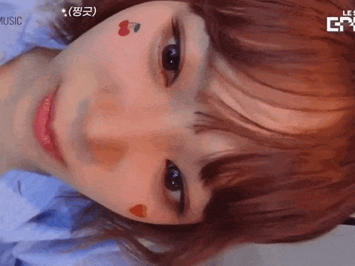 a close up of a girl 's face with a cherry on her face