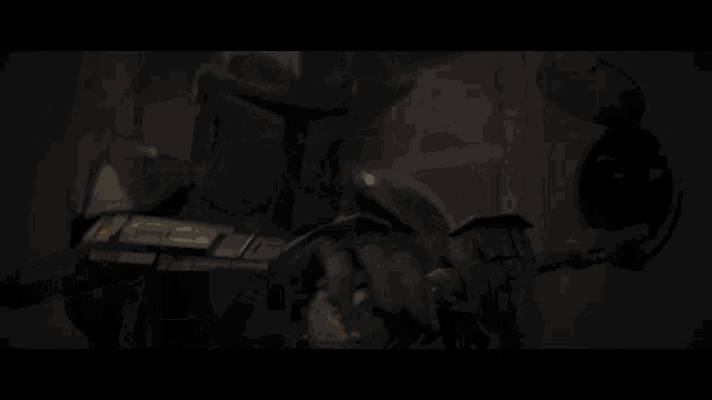 a man is holding a gun in front of a wall