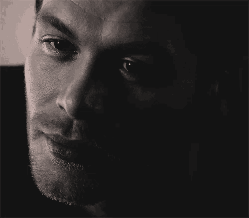 a close up of a man 's face in the dark