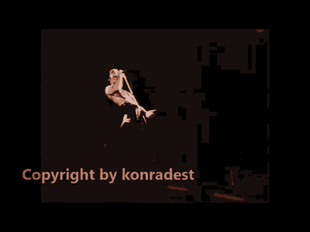 a man without a shirt is singing into a microphone on a stage with the words copyright by konradest below him .