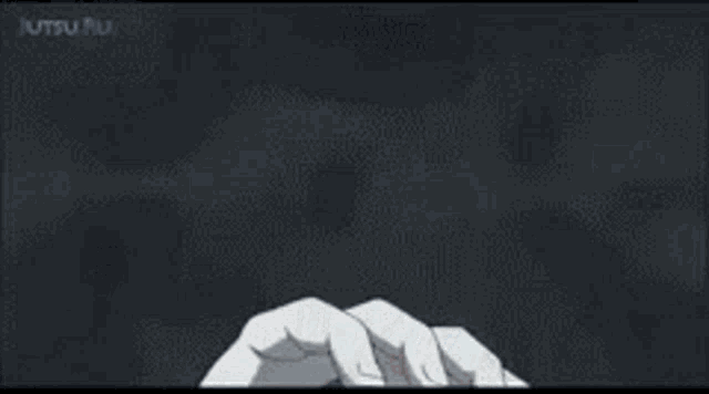 two anime characters are fighting each other in a dark room .