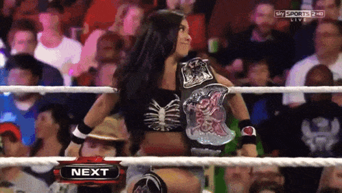 a woman in a wrestling ring next to a sky sports 2 hd sign