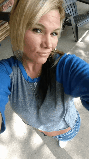 a woman taking a selfie wearing a key necklace