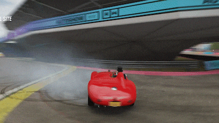 a red car is drifting on a race track with the website visible in the upper right corner