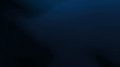 a dark underwater scene with a green light coming out of the bottom