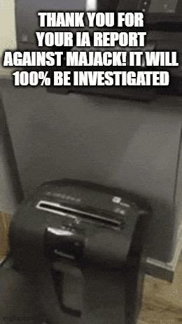 a paper shredder is sitting on a table next to a printer .