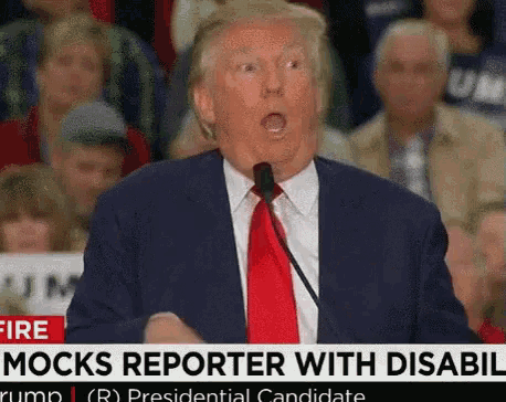 a man in a suit and red tie is speaking into a microphone with a headline that says mock reporter with disabled