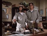 a man and a woman are standing next to each other in a room