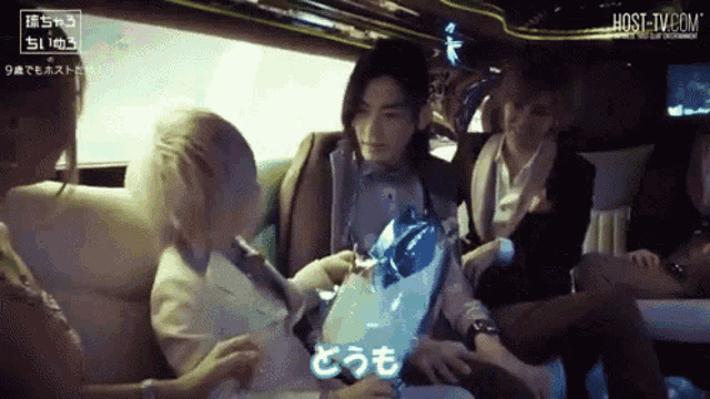 a group of people sitting in a limousine with host-tv.com written on the bottom right