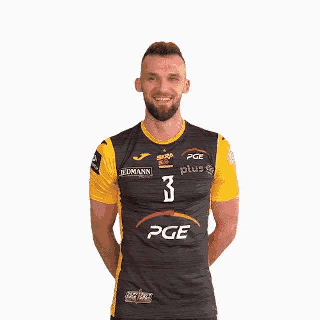 a man wearing a black and yellow pge shirt