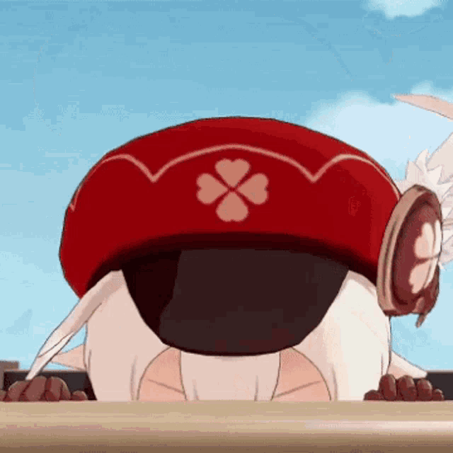 a cartoon character wearing a red hat with a clover on it is looking down at something .