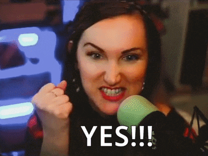 a woman giving a thumbs up in front of a green microphone with the word yes written on the screen