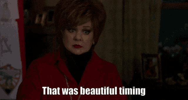 a woman says that was beautiful timing in a red coat