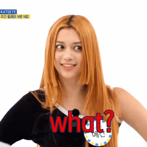 a woman with long red hair is smiling and says what