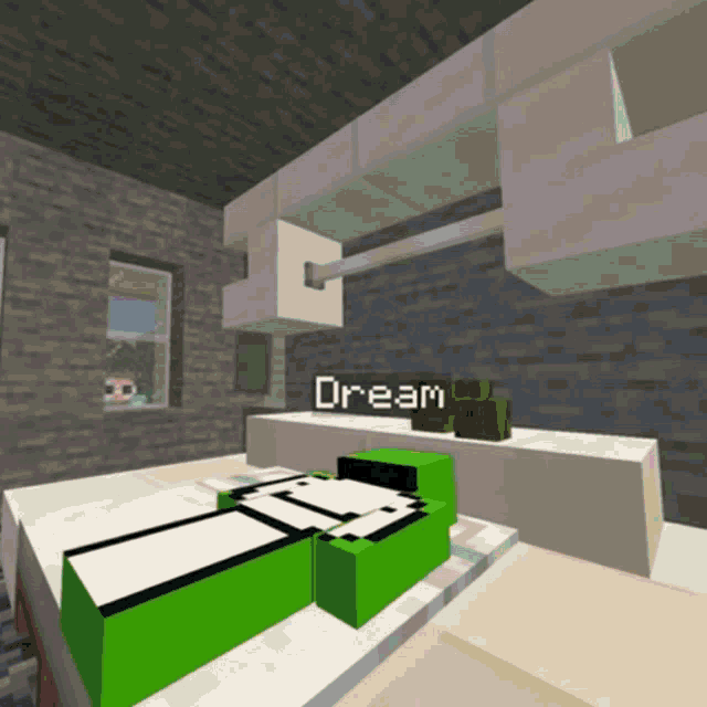 a green and white block with the word dream on it sits on a table