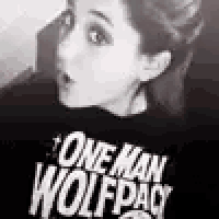 a woman is wearing a t-shirt that says one man wolfpack .