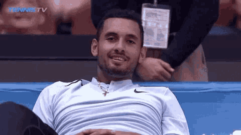a tennis player is smiling while watching a match on tennistv