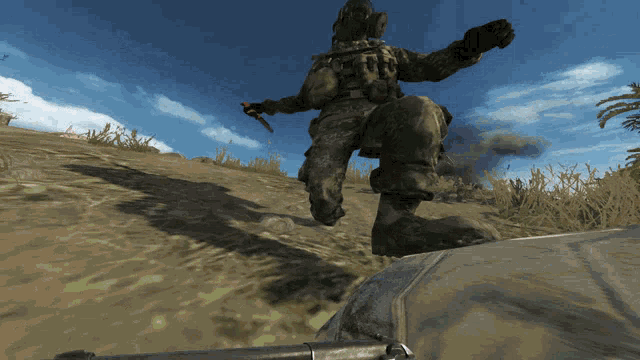 a soldier in a video game is walking up a hill