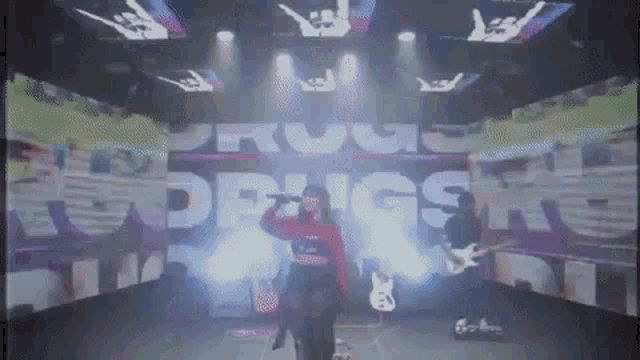 a group of people are on a stage with the word drugs behind them