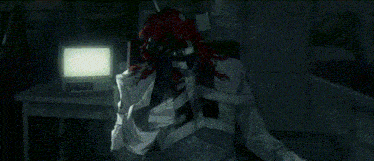 a clown with red hair is sitting in front of a computer screen .