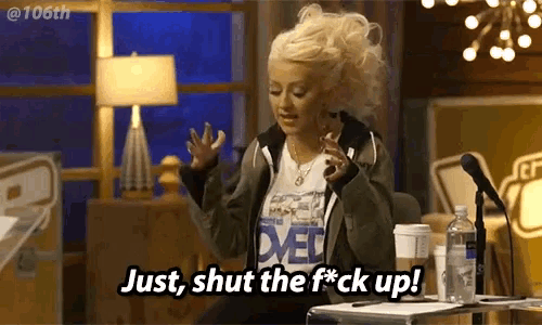 a blonde woman says just shut the f * ck up in front of a microphone