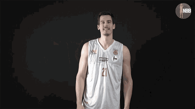 a basketball player with the number 2 on his jersey giving a thumbs up