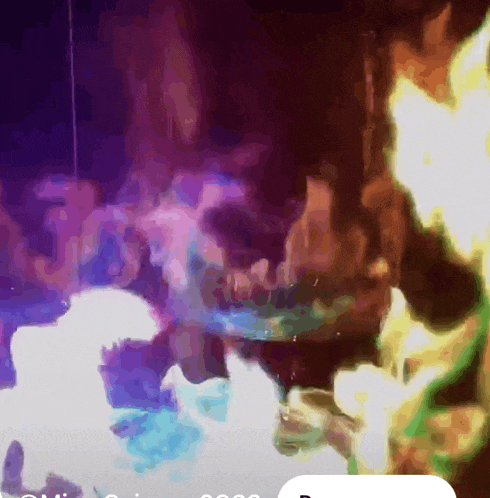 a blurry picture of a fire with a purple background and a white border