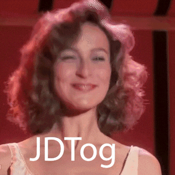 a woman is smiling with the words jdtog on her chest