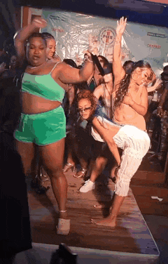 a group of women are dancing in a club .