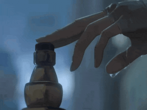 a close up of a person 's hand touching a statue
