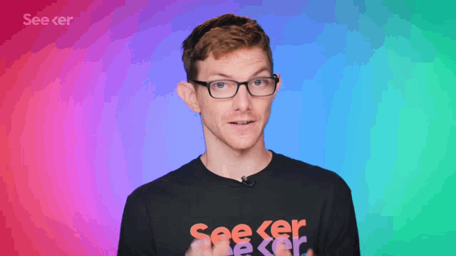 a man with glasses says you 're right in front of a colorful background