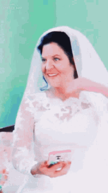 a woman in a white wedding dress is smiling