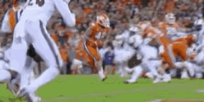 a football game is being played on a field with a lot of players on it .