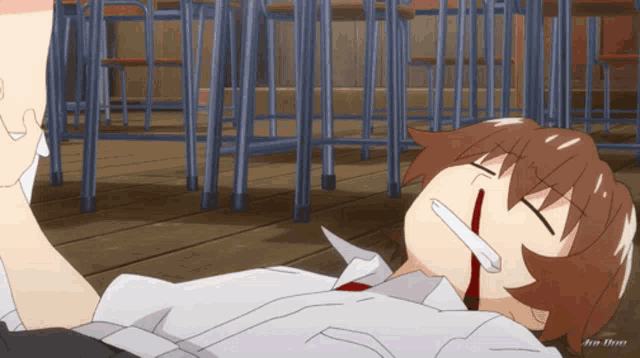 a man with a bloody nose is laying on the ground