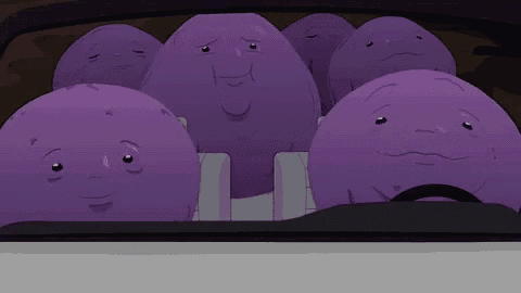 a bunch of purple potatoes with faces are sitting in a car .