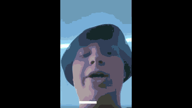 a man wearing a black hat with the words just watching on the bottom